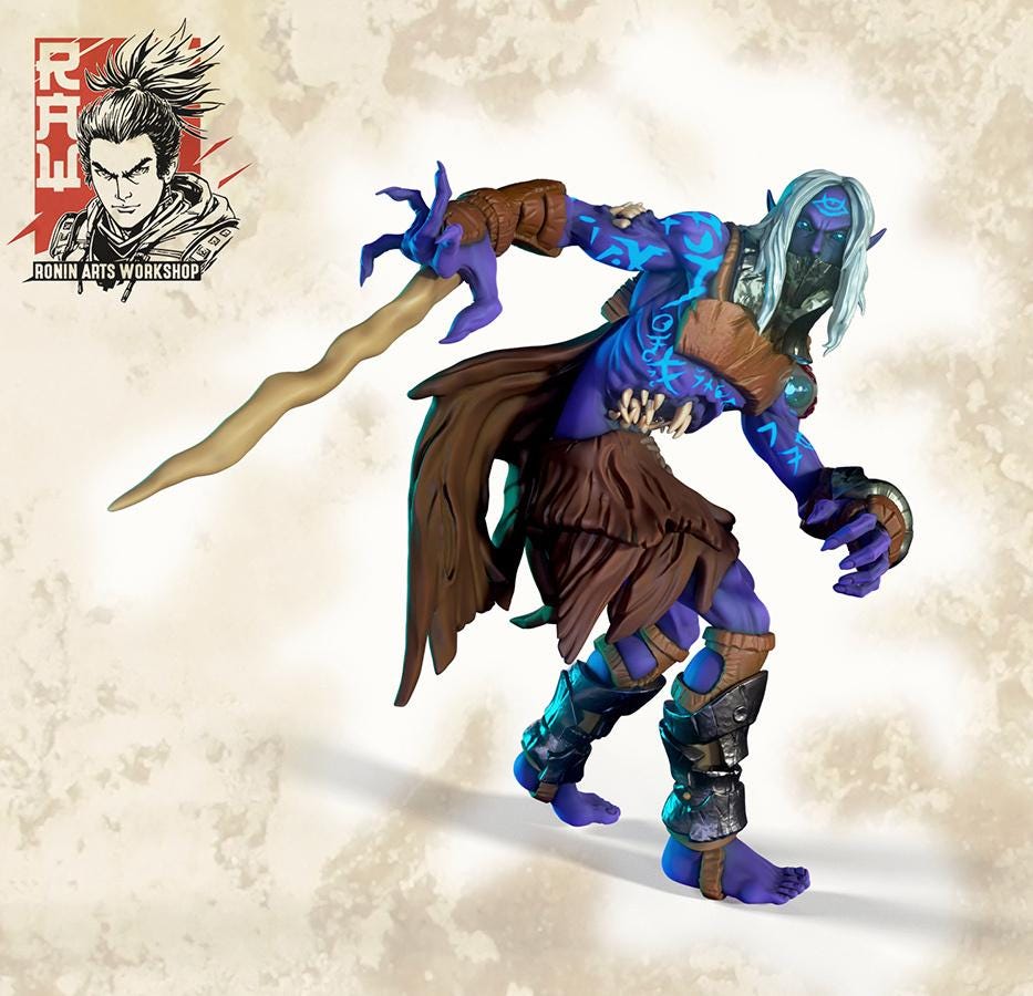 Dumariel by RoninArtsWorkshop, from WintersailMiniatures, is a detailed grey resin fantasy figure with blue skin, white hair, tribal markings, armor, a brown skirt, and a wavy staff, dynamically posed. Logo shown in the corner.